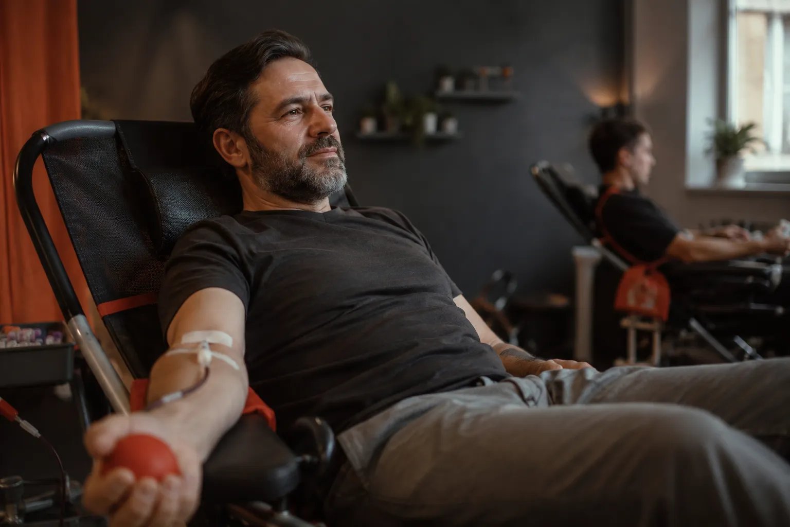 Man having blood drawn during therapeutic phlebotomy while on testosterone therapy