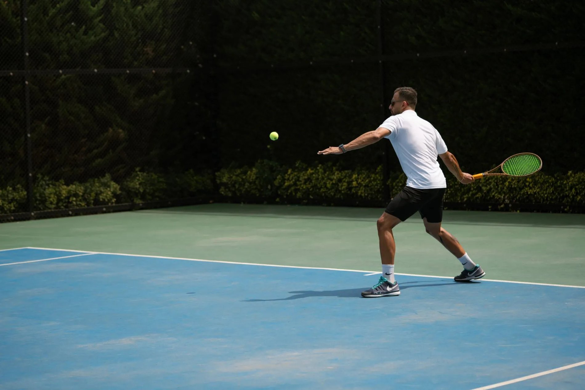 A man playing tennis outdoors while taking bioidentical hormones for men