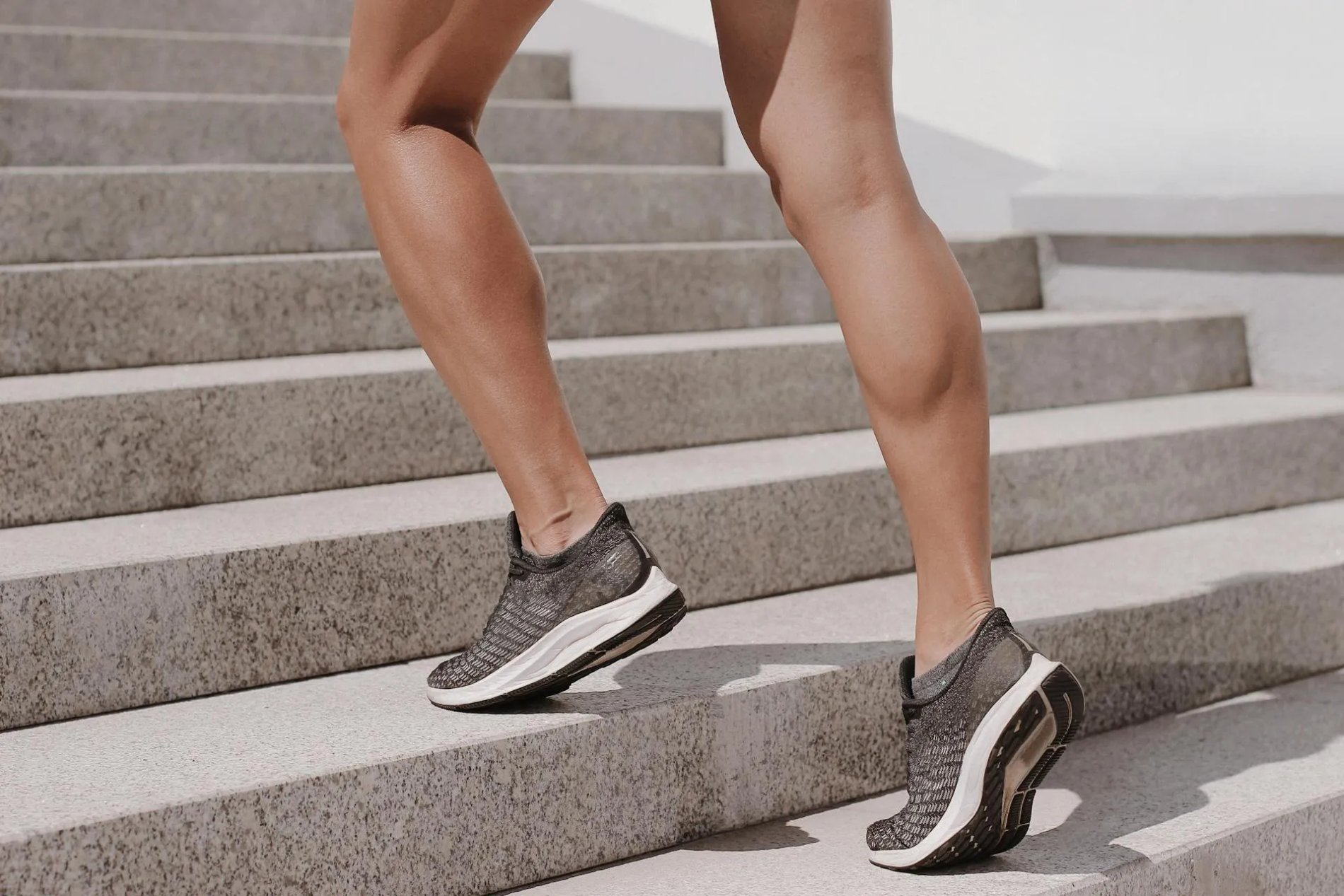 A close up photo of women’s legs walking up the stairs for heart health