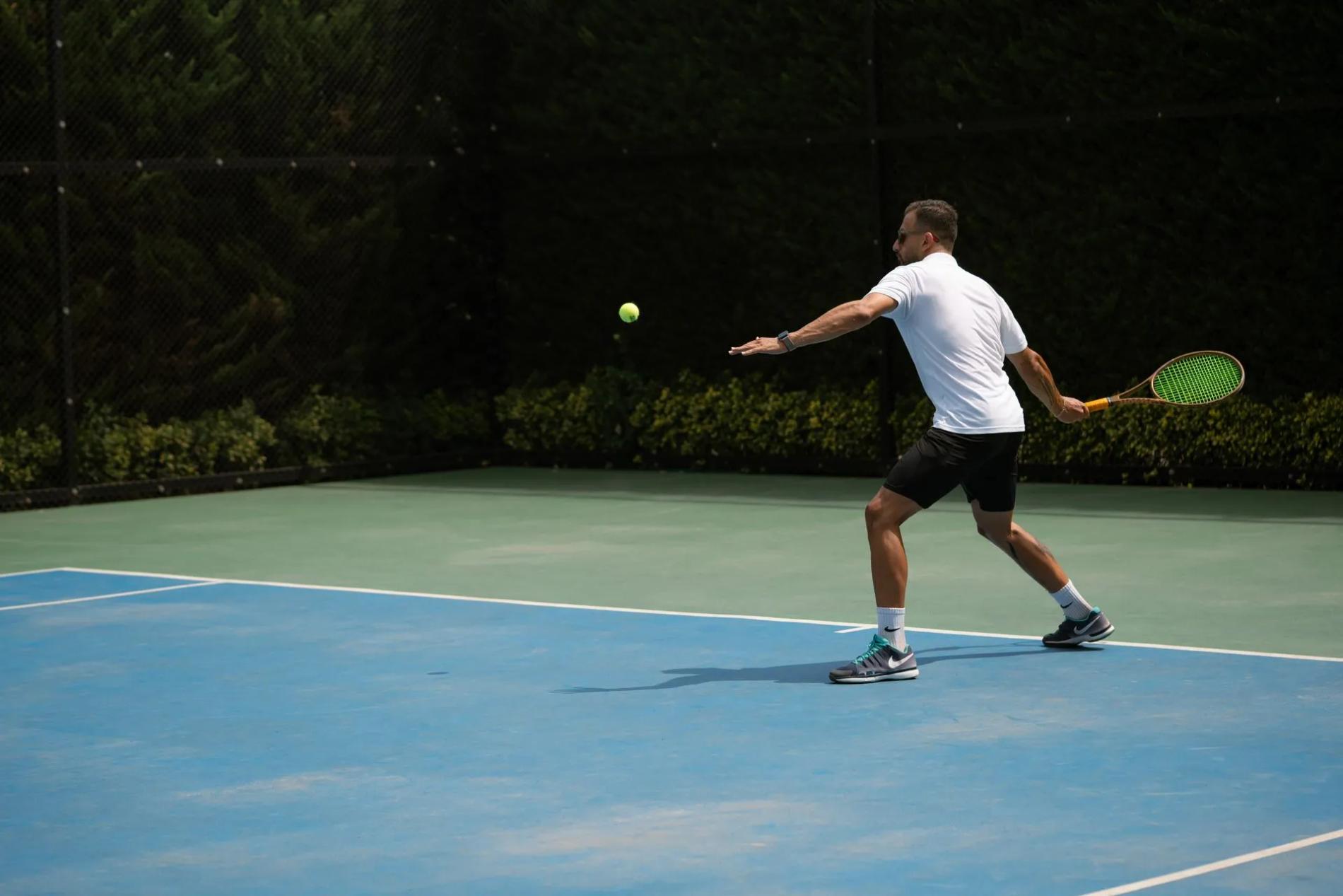 A man playing tennis outdoors while taking bioidentical hormones for men